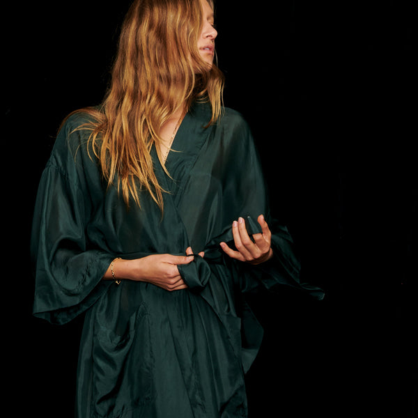 Girl with Blonde Hair wearing a Green Silk Kimono Robe tying her belt