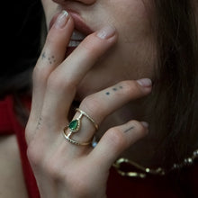 Load image into Gallery viewer, 14k yellow gold ring with emerald on hand against womans face 
