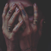 Load image into Gallery viewer, girl with her hands over her face wearing rings 

